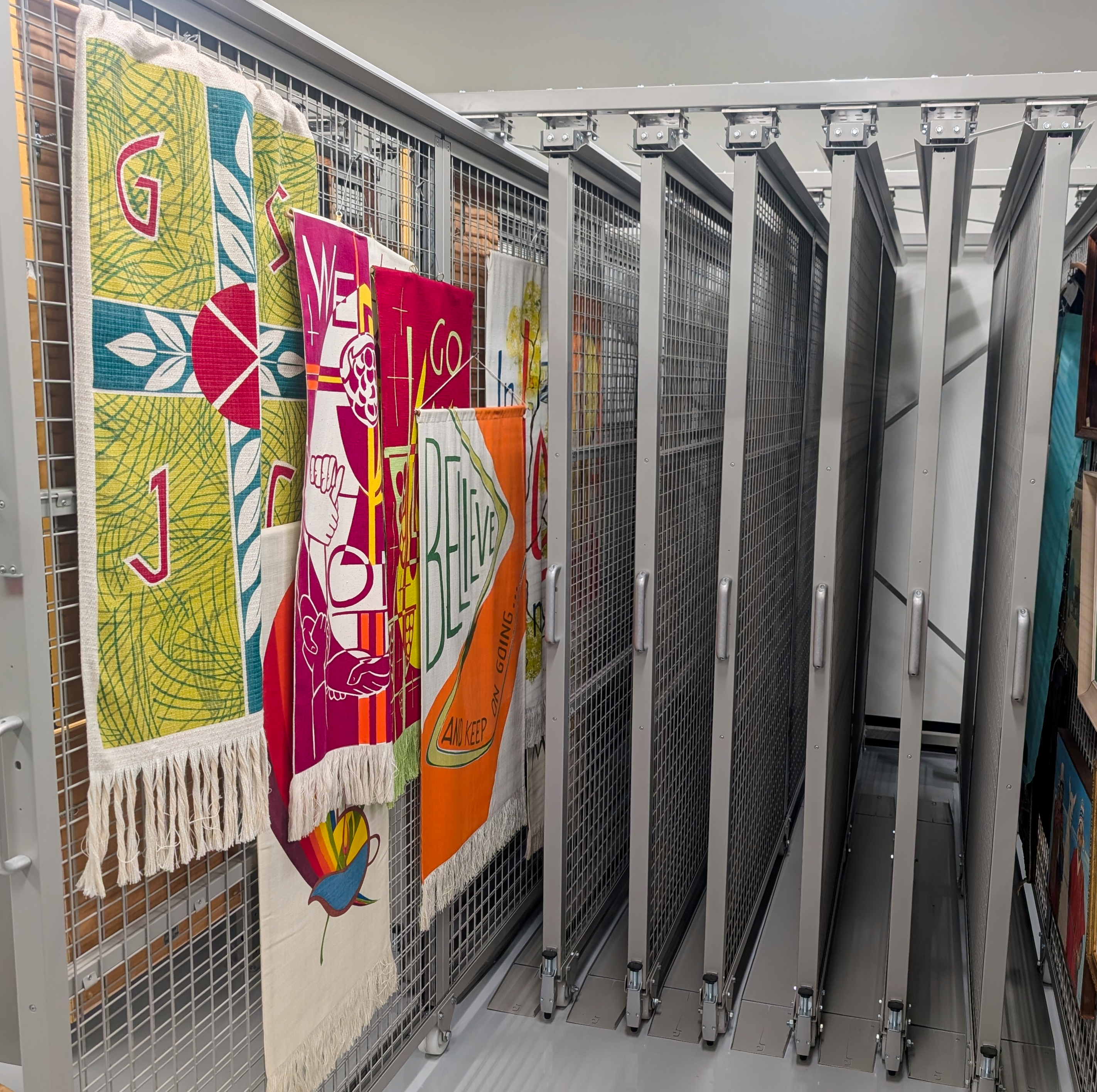 Moveable art racks for vertical storage of ecclesiastical textiles and framed works